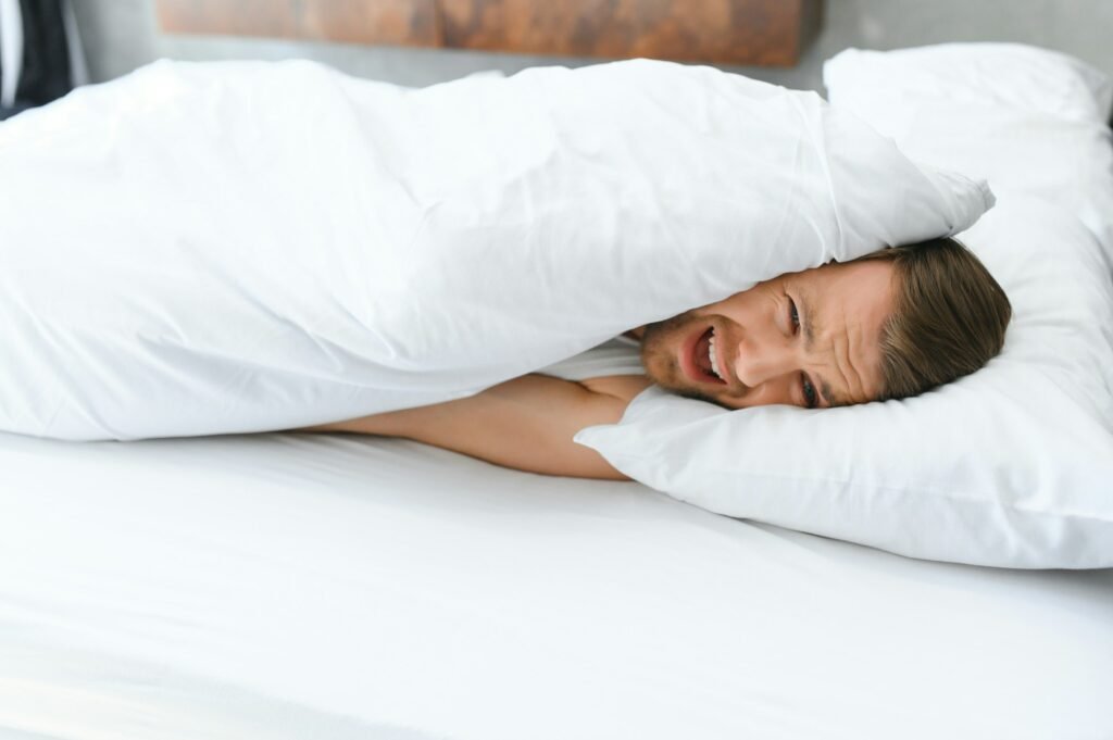 Young man in bed , trying to sleep